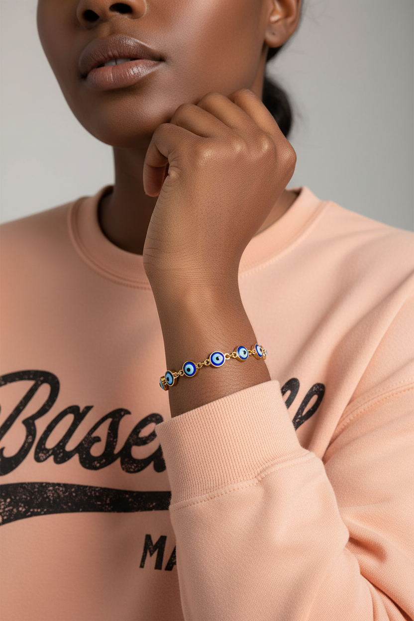 Woman wearing Baseball Mama sweatshirt with Evil Eye Bracelet